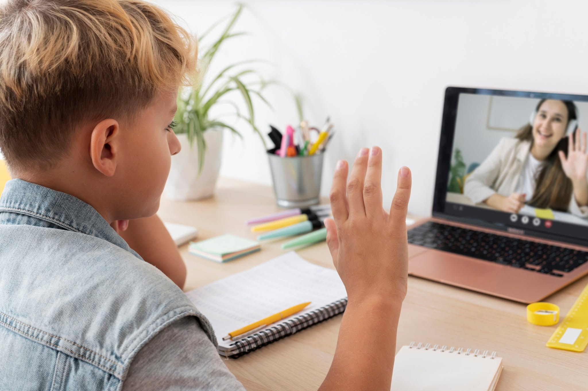 Young girl with headphones smiling during online elementary school class