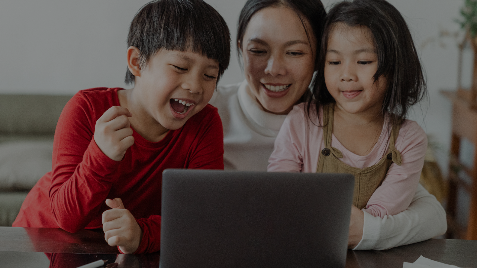 Online elementary school student learning from Wellspring Young girl with headphones smiling during online elementary school class